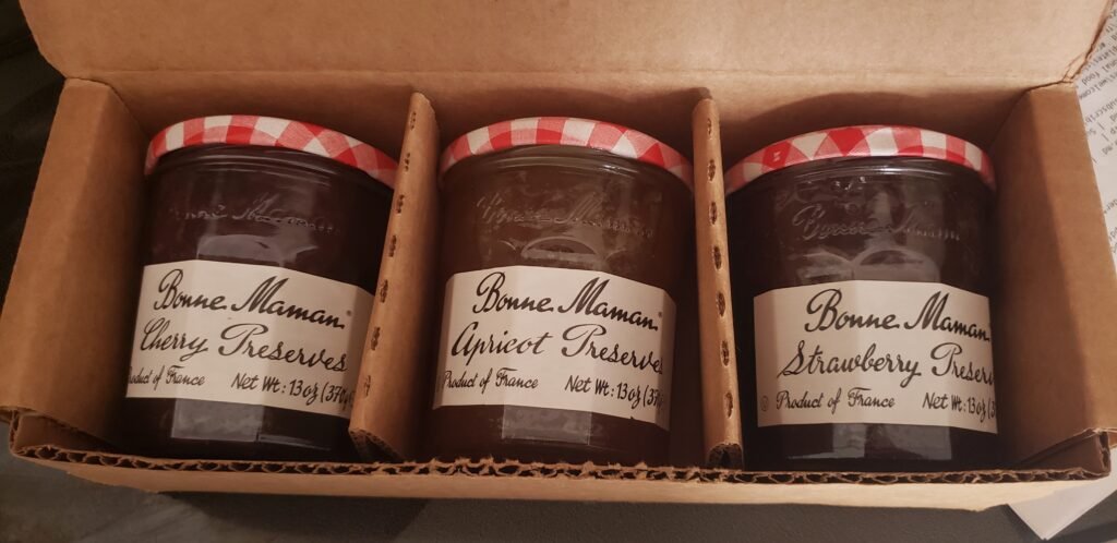 Open cardboard 3-pack of Bonne Maman 13 ounce preserves: cherry, apricot, and strawberry.